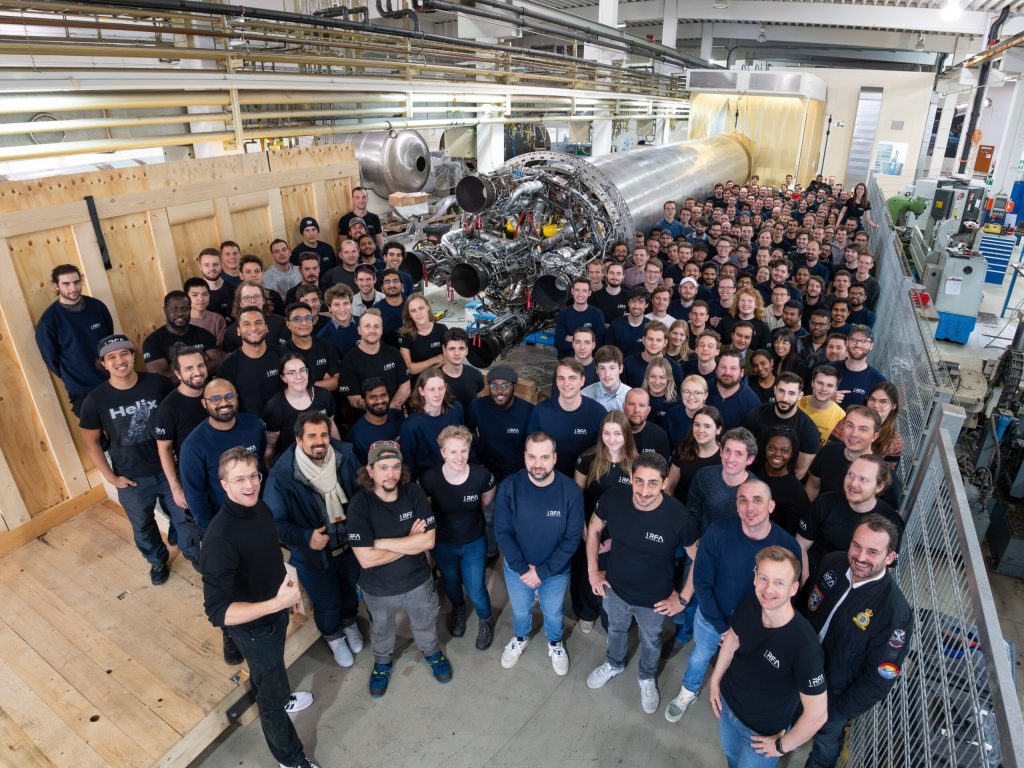 The RFA startup team together with the partially assembled first stage of the RFA One rocket.