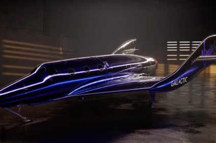 Virgin Galactic futuristic spaceplane in sleek metallic finish inside hangar, designed for commercial suborbital space tourism